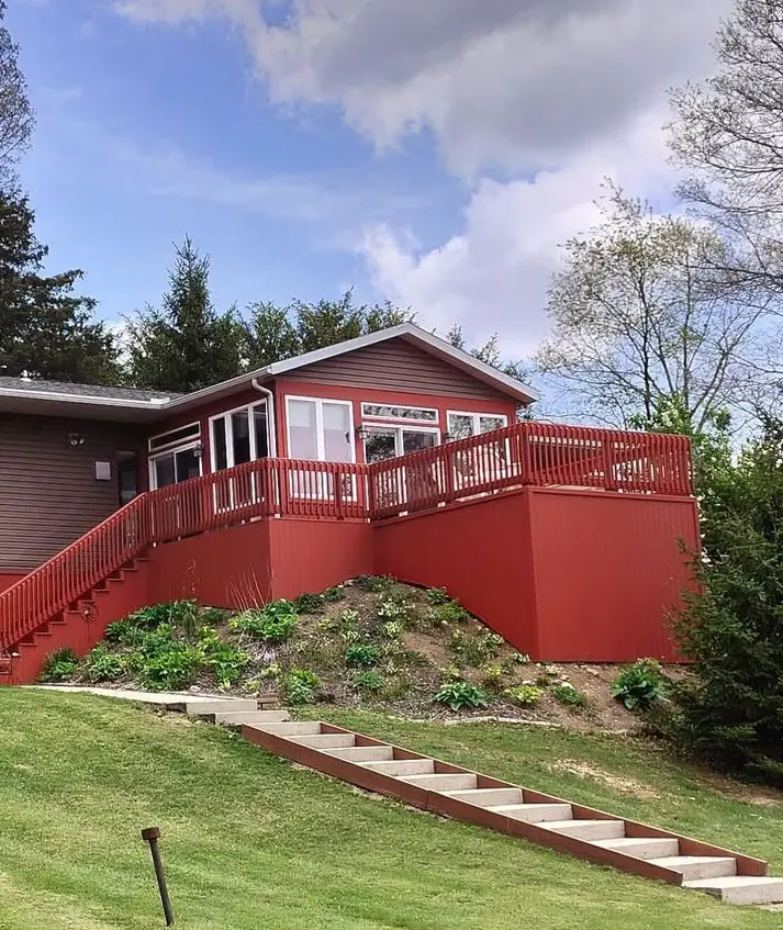Home-Exterior View of a homes exterior with a large deck and a new paint job